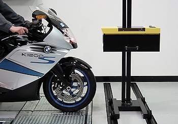 Headlight beam tester being used to test a motorbike